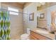 Clean bathroom with walk-in shower, granite countertops, and wood cabinets at 5550 Rock Dove Dr, Sarasota, FL 34241