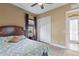 Bedroom featuring hardwood floors, a ceiling fan, and a view to an outdoor patio at 5550 Rock Dove Dr, Sarasota, FL 34241