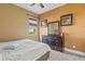 Comfortable bedroom with painted walls, a fan, and a wooden dresser at 5550 Rock Dove Dr, Sarasota, FL 34241