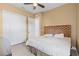 Bright bedroom featuring a ceiling fan, white closets, and wood-style floors at 5550 Rock Dove Dr, Sarasota, FL 34241