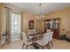 Charming dining room with chandelier and display cabinet at 5550 Rock Dove Dr, Sarasota, FL 34241