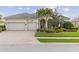 Beautiful home with a three-car garage, brick paved driveway, and covered front entry with decorative columns at 5550 Rock Dove Dr, Sarasota, FL 34241