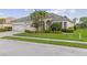 Gorgeous front exterior with manicured landscaping and a three-car garage at 5550 Rock Dove Dr, Sarasota, FL 34241
