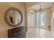 Welcoming foyer with tile flooring, decorative mirror, and an elegant chandelier at 5550 Rock Dove Dr, Sarasota, FL 34241