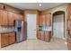 Well-lit kitchen showcasing stainless steel refrigerator and beautiful wood cabinetry at 5550 Rock Dove Dr, Sarasota, FL 34241
