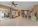 Spacious living room featuring tile floors, ceiling fan and seamless access to the outdoor living area at 5550 Rock Dove Dr, Sarasota, FL 34241