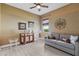 Comfortable living room featuring gray sofa, decorative accents, and neutral walls at 5550 Rock Dove Dr, Sarasota, FL 34241