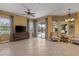 Bright living room with tile flooring, ceiling fan, and sliding glass doors leading to the lanai at 5550 Rock Dove Dr, Sarasota, FL 34241