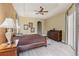 Beautifully designed main bedroom with tray ceiling, ceiling fan, ensuite bathroom and dresser at 5550 Rock Dove Dr, Sarasota, FL 34241