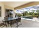 Outdoor living space with screened-in pool and spa offering serene views of the surrounding landscape at 5550 Rock Dove Dr, Sarasota, FL 34241