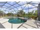 Inviting screened-in pool and hot tub overlooking the lake at 5550 Rock Dove Dr, Sarasota, FL 34241