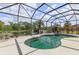 Relaxing screened pool with a spa, patio, and lake views to make the most of outdoor living at 5550 Rock Dove Dr, Sarasota, FL 34241