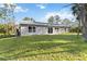 Spacious backyard with vibrant green grass and ample sunlight, ideal for outdoor activities and relaxation at 5761 Centro Ave, North Port, FL 34288