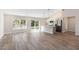 Open concept living space with wood-look flooring and abundant natural light at 5761 Centro Ave, North Port, FL 34288