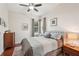 Comfortable bedroom features a ceiling fan, a luxurious bed, and coordinated decor at 614 Pond Willow Ln, Venice, FL 34292