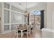 Elegant dining room featuring decorative wall accents, chandelier, and ample natural light at 614 Pond Willow Ln, Venice, FL 34292
