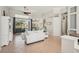 Spacious living room with tile floors, sliding glass doors and comfortable seating arrangement at 614 Pond Willow Ln, Venice, FL 34292