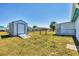 Backyard features shed for storage, fenced in yard, and additional outdoor space for entertaining or relaxation at 6392 Coliseum Blvd, Port Charlotte, FL 33981