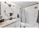 Bright bathroom featuring a single vanity, shower-tub combo, and modern finishes at 6392 Coliseum Blvd, Port Charlotte, FL 33981
