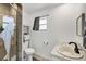 Modern bathroom features a glass-enclosed shower, single sink, and decorative dolphin at 6392 Coliseum Blvd, Port Charlotte, FL 33981
