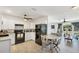 Updated kitchen featuring white cabinetry, modern appliances, and an adjacent dining area at 6392 Coliseum Blvd, Port Charlotte, FL 33981