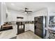 Modern kitchen with white cabinets, black appliances, and a breakfast nook at 6392 Coliseum Blvd, Port Charlotte, FL 33981