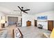 Spacious open-concept living area with modern ceiling fan and tile flooring throughout the home at 6392 Coliseum Blvd, Port Charlotte, FL 33981