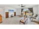 Cozy living room area with wood-look floors, bright windows, and comfortable seating at 6392 Coliseum Blvd, Port Charlotte, FL 33981