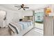 Comfortable bedroom with a large window, ceiling fan, and ample natural light at 6392 Coliseum Blvd, Port Charlotte, FL 33981