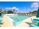 Community pool view with clear water, lounge chairs, and lake views on a sunny day at 6392 Coliseum Blvd, Port Charlotte, FL 33981