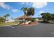 Exterior view of community recreation center entrance and parking with manicured landscaping and pedestrian bridge walkway at 6392 Coliseum Blvd, Port Charlotte, FL 33981