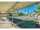 Exterior view of community shuffleboard courts, covered seating, and landscaping at 6639 Vista Ln, North Port, FL 34287