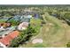 Aerial view of golf course, tennis courts, clubhouse, parking lot and residential area at 7324 Links Ct, Sarasota, FL 34243
