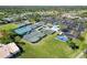 Aerial view of tennis courts, clubhouse, and parking lot in a well-maintained community at 7324 Links Ct, Sarasota, FL 34243