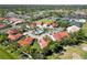 Aerial view of a circle of houses surrounding a community pool, with manicured lawns at 7324 Links Ct, Sarasota, FL 34243