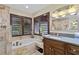 Elegant bathroom featuring a bathtub, marble tiled shower, and stylish vanity at 7324 Links Ct, Sarasota, FL 34243
