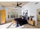 Bright bedroom with ceiling fan, plantation shutters, and elegant furniture at 7324 Links Ct, Sarasota, FL 34243