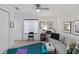 Bright bonus room featuring a ceiling fan, window with blinds, and comfortable seating at 7324 Links Ct, Sarasota, FL 34243