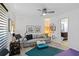 Bright bonus room featuring a ceiling fan, comfortable seating, and natural light at 7324 Links Ct, Sarasota, FL 34243