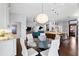 Open dining area with modern chandelier adjacent to the gourmet kitchen and living area at 7324 Links Ct, Sarasota, FL 34243