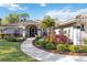 Stunning front entrance with meticulously landscaped flowerbeds and inviting walkway at 7324 Links Ct, Sarasota, FL 34243