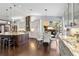Open kitchen boasts granite countertops, island, and seamless flow to dining area at 7324 Links Ct, Sarasota, FL 34243
