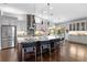 Modern kitchen with stainless steel refrigerator, island, and a view of the dining area at 7324 Links Ct, Sarasota, FL 34243