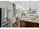 Open kitchen with a large island, stainless steel refrigerator, and custom cabinets at 7324 Links Ct, Sarasota, FL 34243