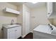 Clean laundry room with a white washer and dryer, sink, and ample storage space at 7324 Links Ct, Sarasota, FL 34243