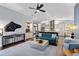 Spacious living room featuring modern decor, hardwood floors, an open layout, and views into the kitchen at 7324 Links Ct, Sarasota, FL 34243