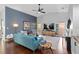 Stylish living room with high ceilings, modern furnishings, hardwood floors, and large windows at 7324 Links Ct, Sarasota, FL 34243