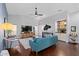 Open-concept living room featuring hardwood floors, modern decor, and views of the bar and entertainment center at 7324 Links Ct, Sarasota, FL 34243