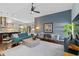 Bright living room featuring a comfortable sofa, stylish decor, an open floor plan, and hardwood flooring at 7324 Links Ct, Sarasota, FL 34243