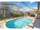 A sparkling screened-in pool with lush landscaping and comfortable outdoor seating at 7324 Links Ct, Sarasota, FL 34243